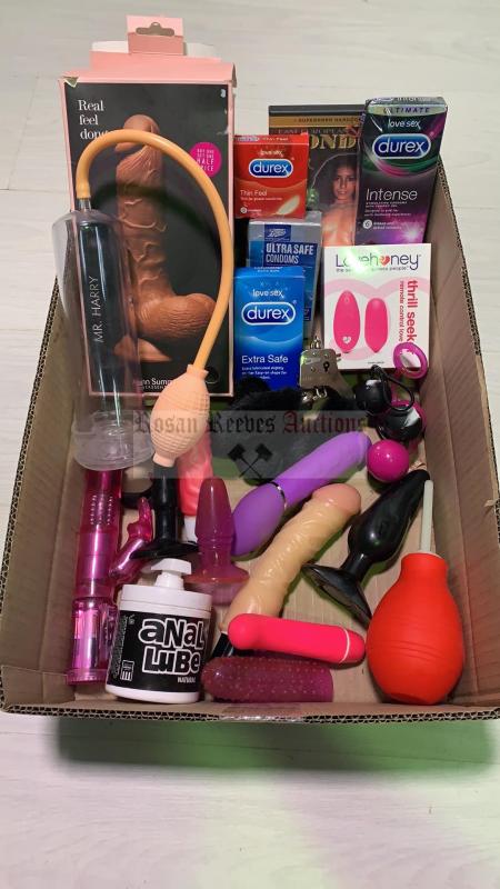 A carton containing assorted adult toys condoms etc