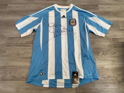 A carton containing a signed Ossie Ardiles Argentina football shirt